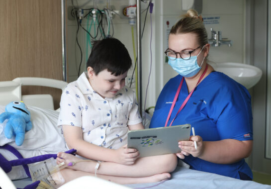 Nurse with child on ward