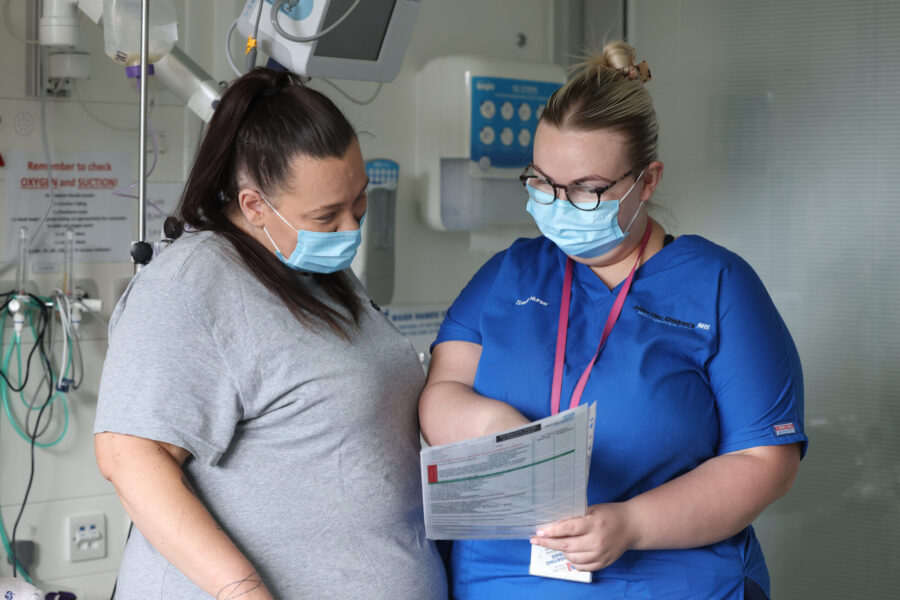 Nurse with parent looking at a form