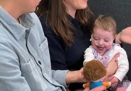 Parents post with their baby in Alder Hey's Innovation Hub