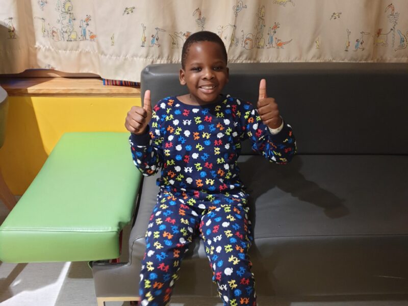 Photo of Joshua sat down giving two thumbs up